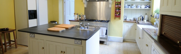 Traditional style painted kitchen with slate island worktop